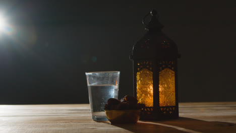 Stationary-Shot-of-Lantern-Water-and-Dates-On-Table-for-Ramadan
